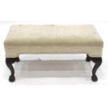 A Carved Mahogany Window Seat, probably 19th century, recovered in a modern cream fabric with