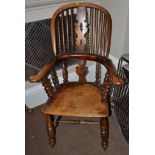 A Mid 19th Century Ash High-Back Windsor Armchair, the double spindle back support above curved