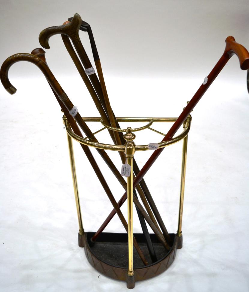 A Brass Stick Stand, late 19th century, of demi-lune form with baluster finials, 63cm high, with