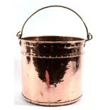 A Copper Bucket, of cylindrical form with brass overhead loop handle, 33cm high