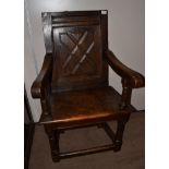 A 17th Century Joined Oak Wainscot Armchair, the relief carved back panel above downswept arms and