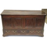 A George III Oak Chest, early 19th century, the hinged lid above four moulded panels all between