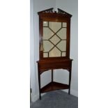 An Edwardian Mahogany Free-Standing Corner Cupboard, early 20th century, the fret carved