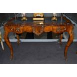 A Victorian Figured Walnut and Crossbanded Bureau Plat, late 19th century, in Louis XV style, of