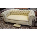 A Chesterfield Two-Seater Double Drop-End Sofa, recovered in buttoned yellow floral fabric, the