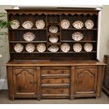 A Mid 18th Century Enclosed Oak Dresser Base, with a central bank of three drawers flanked by fluted