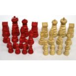 An Early 20th Century Red Stained and Natural Ivory Chess Set, Pawns 4.5cm, Kings 9cm. One white