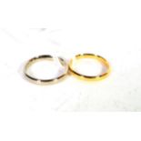 An 18 carat gold band ring, finger size M; and an 18 carat white gold band ring, finger size N (