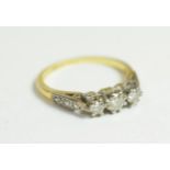 An 18 carat gold diamond three stone ring, finger size L. Gross weight - 2.6 grams