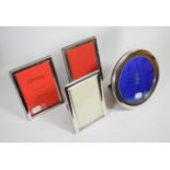 A pair of modern silver rectangular photograph frames with rope border; a plain rectangular example;