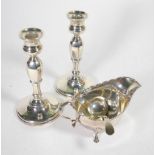 A pair of silver candlesticks, Adie Bros, Birmingham 1926, loaded; together with a silver sauce