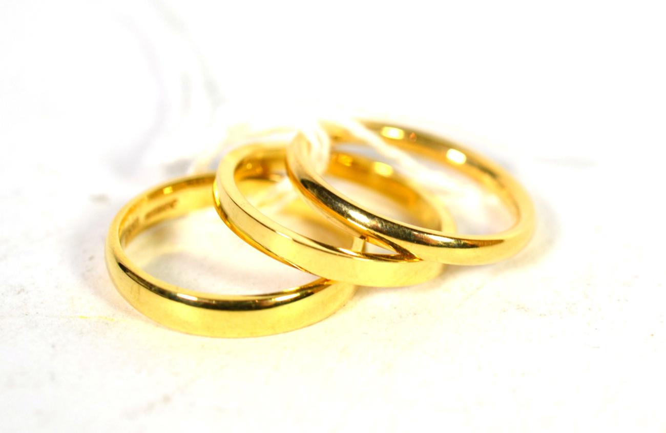 Three 18 carat gold band rings, finger sizes K, L, and L1/2 (3). Gross weight - 8.19 grams