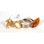 A 9 carat gold abstract cultured pearl ring, finger size K; a 14 carat gold amber ring, finger