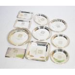 Ten small modern silver commemorative dishes, all engraved Manchester 2002, and a similarly engraved