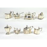 A collection of nine various silver mustard pots, various makers, late 19th and 20th century, with