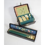 A cased Mahjong set and a Japanned fan box containing a set of bone dominoes