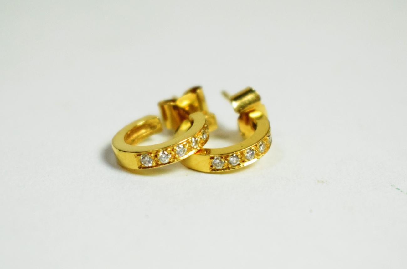 A pair of 18 carat gold and diamond earrings, with post fittings for pierced ears (2). Gross