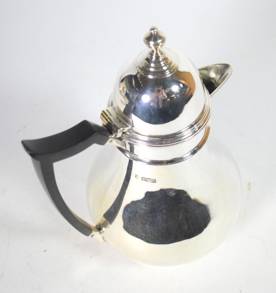 An Edwardian silver hot water jug, Thomas Bradbury & Sons, Sheffield 1909, baluster with domed cover