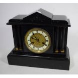 A Victorian black slate striking mantel clock