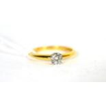 An 18 carat gold solitaire diamond ring, a round brilliant cut diamond in a claw setting, to knife