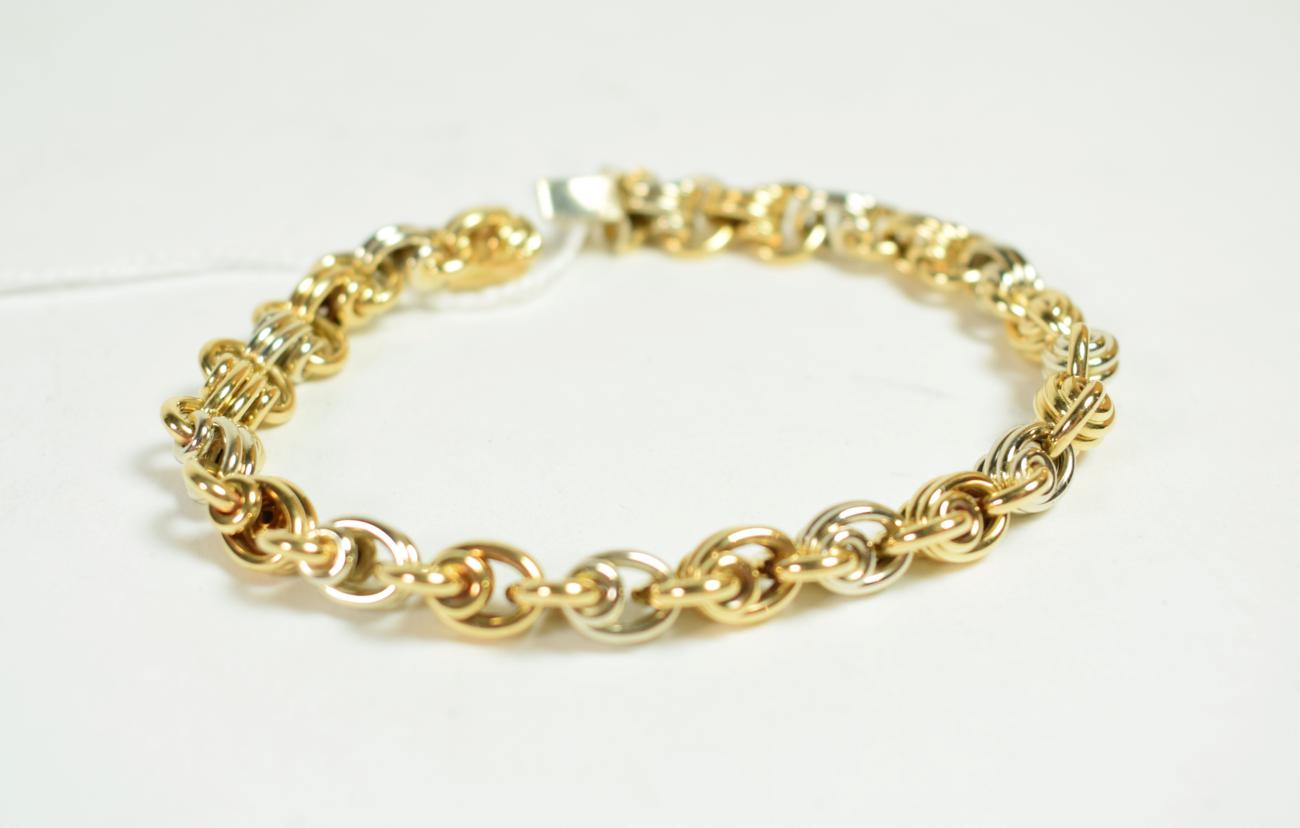 An 18 carat two colour gold fancy link bracelet with sapphire set clasp, length 19cm . Gross