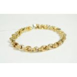 An 18 carat two colour gold fancy link bracelet with sapphire set clasp, length 19cm . Gross