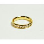 An 18 carat gold channel set diamond half hoop ring, total estimated diamond weight 0.65 carat