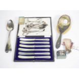A quantity of silver to include assorted spoons; napkin rings; silver handled knives; and a quantity