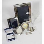 Four silver frames; a French silver plate wine taster; a silver owl form bookmark; a silver thimble;