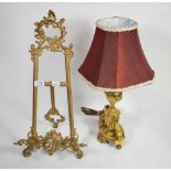 A gilt metal table lamp of urn form decorated with swags together with a reproduction scrolling gilt