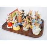 Eleven Royal Doulton Bunnykins figures and one Royal Albert Beatrix Potter figure