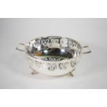 A twin handled silver bowl, S J Levi & Co, Birmingham 1931, with a periced folaite border on three