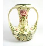 A Cobridge pottery twin-handled vase decorated by Kerry Goodwin in the Florian rose style design,