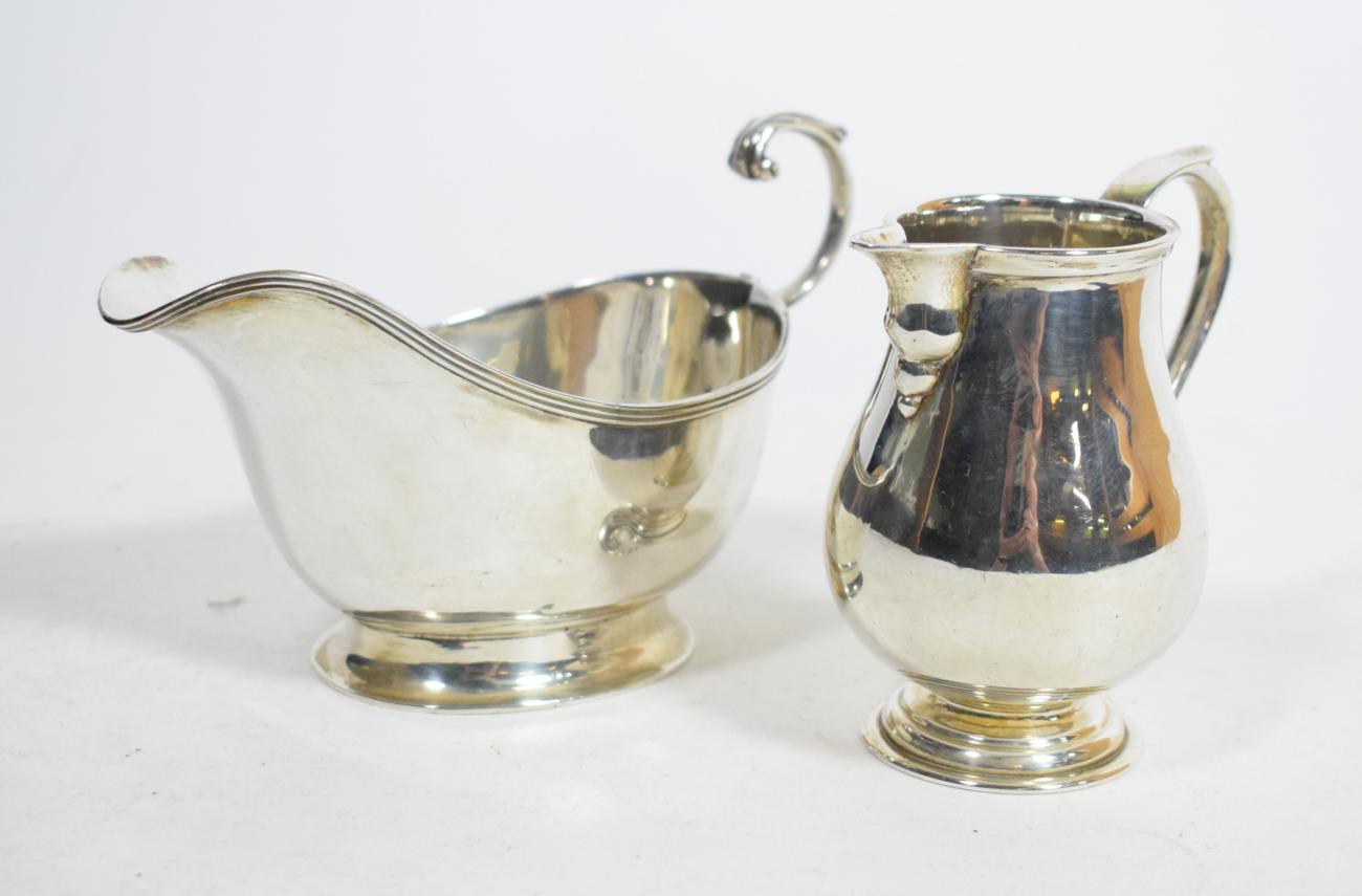 A silver sparrow beak cream jug, London 1917, in the 18th century style; and a silver sauce boat