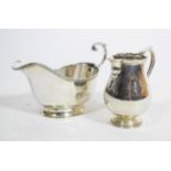 A silver sparrow beak cream jug, London 1917, in the 18th century style; and a silver sauce boat