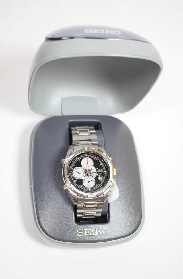 A stainless steel chronograph calendar alarm wristwatch, signed Seiko , with Seiko box and booklets