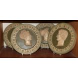 A set of four Neo Classical painted plaster roundels, circa 1900, depicting Roman profiles with a