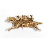 An 18 carat gold brooch modelled as two horses, stamped 'ITALY', length 4cm. Gross weight 6.36