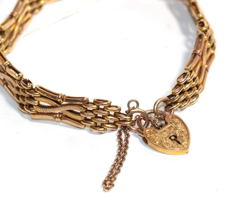 A gate link bracelet with heart shaped padlock clasp, both stamped '9ct', length 19.5cm . Gross