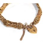 A gate link bracelet with heart shaped padlock clasp, both stamped '9ct', length 19.5cm . Gross