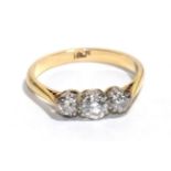 A diamond three stone ring, stamped '18CT', finger size L. Gross weight - 2.40 grams