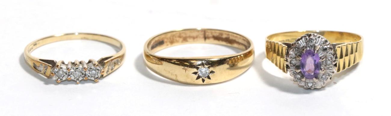 A 9 carat gold diamond solitaire ring, finger size T; a 9 carat gold three stone ring, finger size