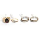 A 9 carat gold gem set ring, finger size M; and three other rings, one stamped '375', finger sizes