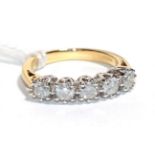 A diamond five stone ring, stamped '750', total estimated diamond weight 0.75 carat approximately,