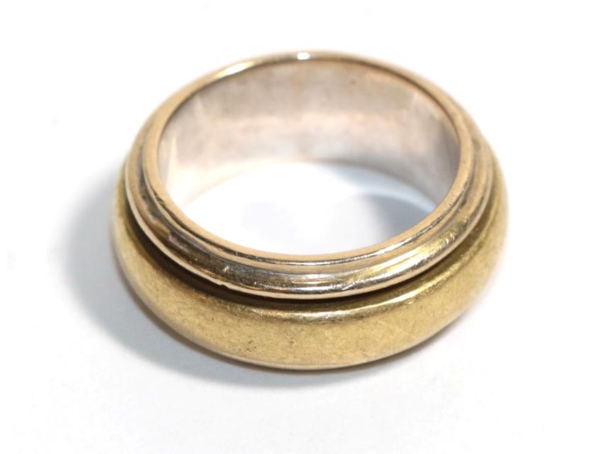 A yellow and white metal band ring, stamped '750', finger size L. Gross weight - 13.25 grams.