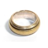 A yellow and white metal band ring, stamped '750', finger size L. Gross weight - 13.25 grams.