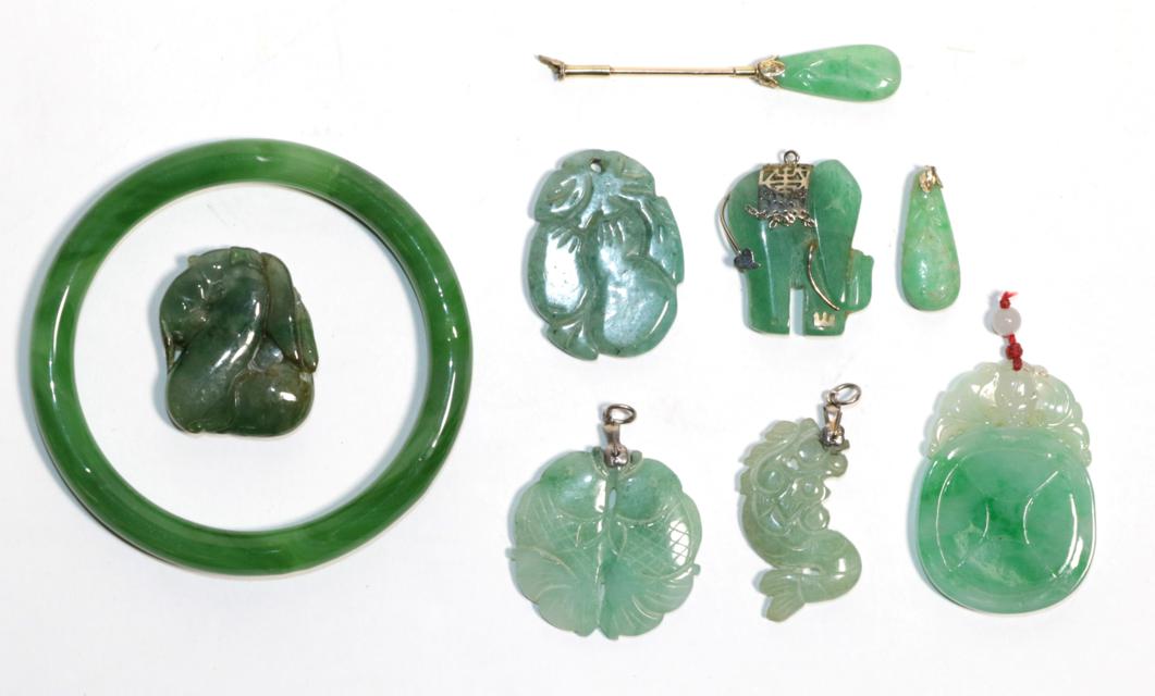 Six jade pendants of varying sizes (a.f.); a jade collar stud (a.f.) and a jade bangle, inner