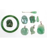 Six jade pendants of varying sizes (a.f.); a jade collar stud (a.f.) and a jade bangle, inner