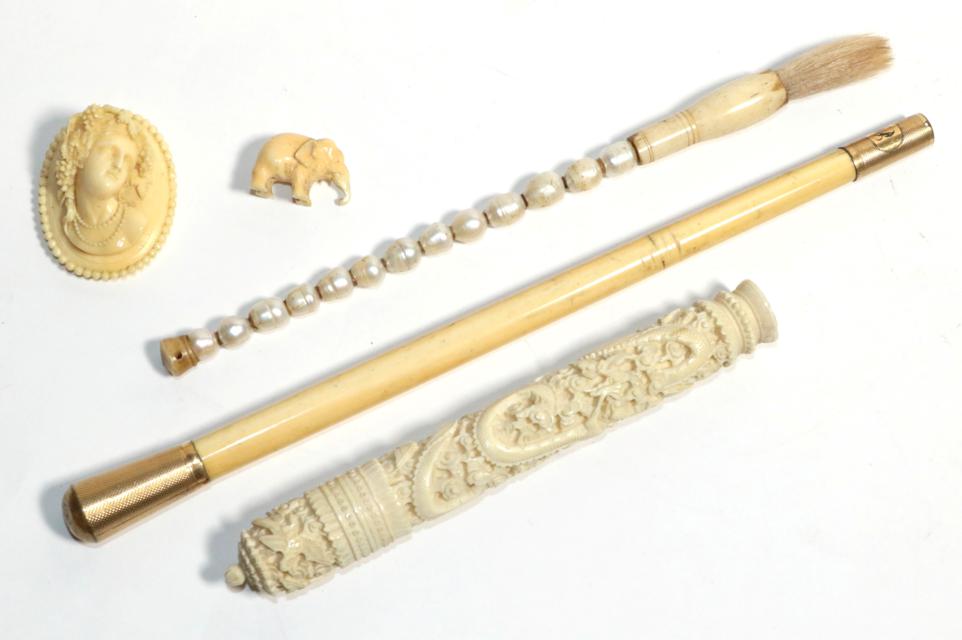 A carved Chinese bodkin case with needles, carved ivory late Victorian cameo, ivory parasol