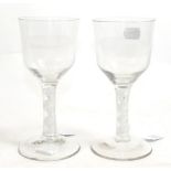 A Pair of Glass Goblets, circa 1750, the ogee bowls on double series opaque twist stems and circular